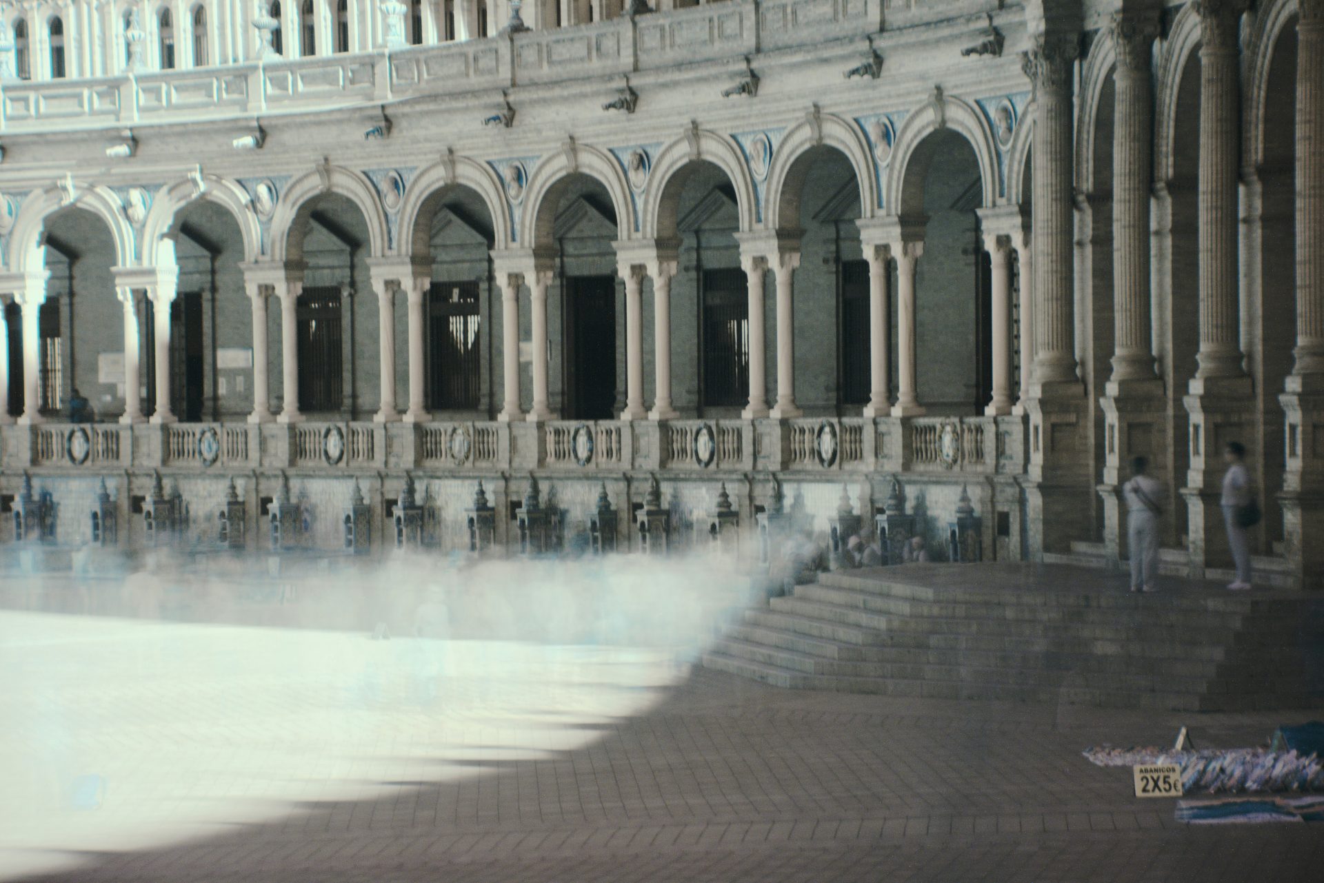 a large building with a pool of water in front of it